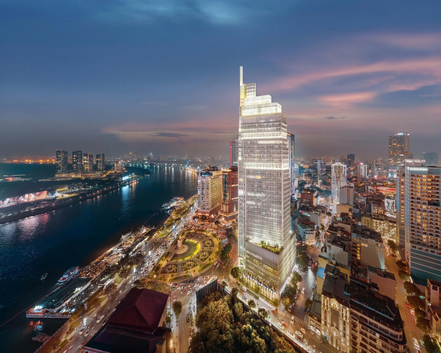 Vietcombank Tower lit up at dusk overlooking Me Linh Square and the Saigon River