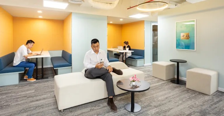 Regus Q2 Thao Dien lounge area with soft seating and meeting booths