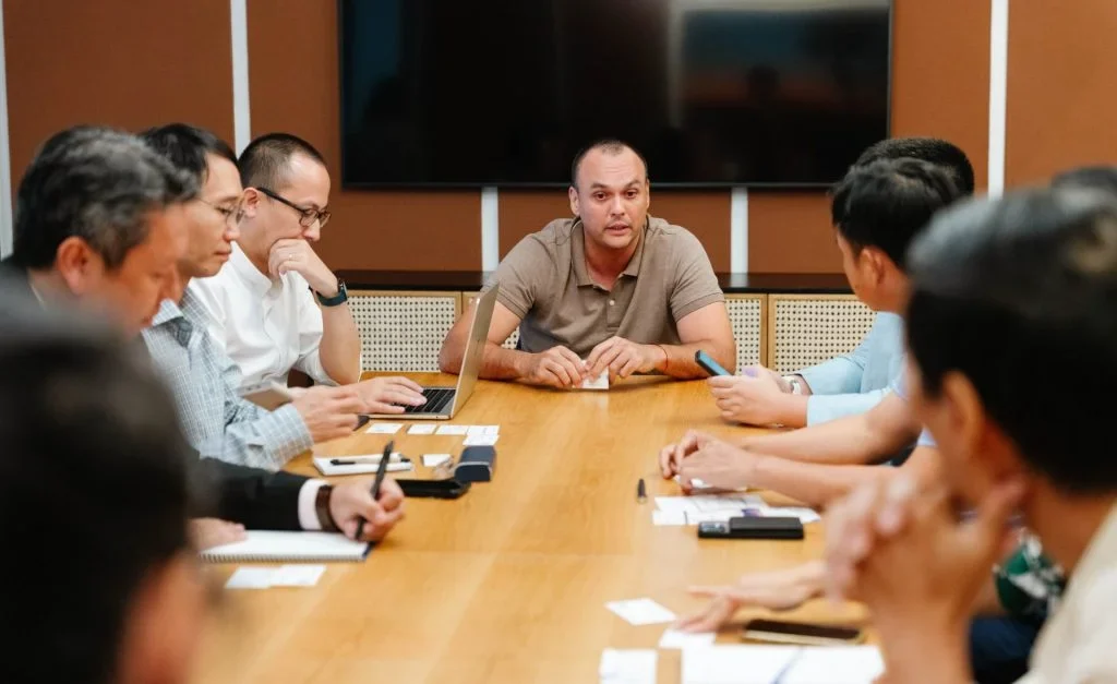 Professionals reviewing business plans around a conference table