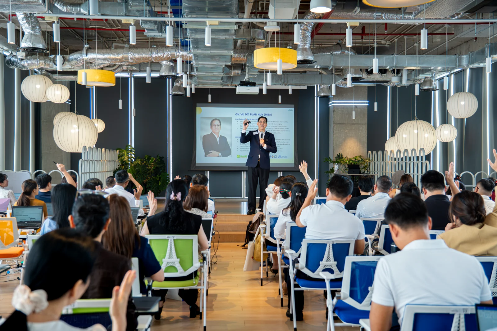 Speaker addressing an audience in a modern workspace