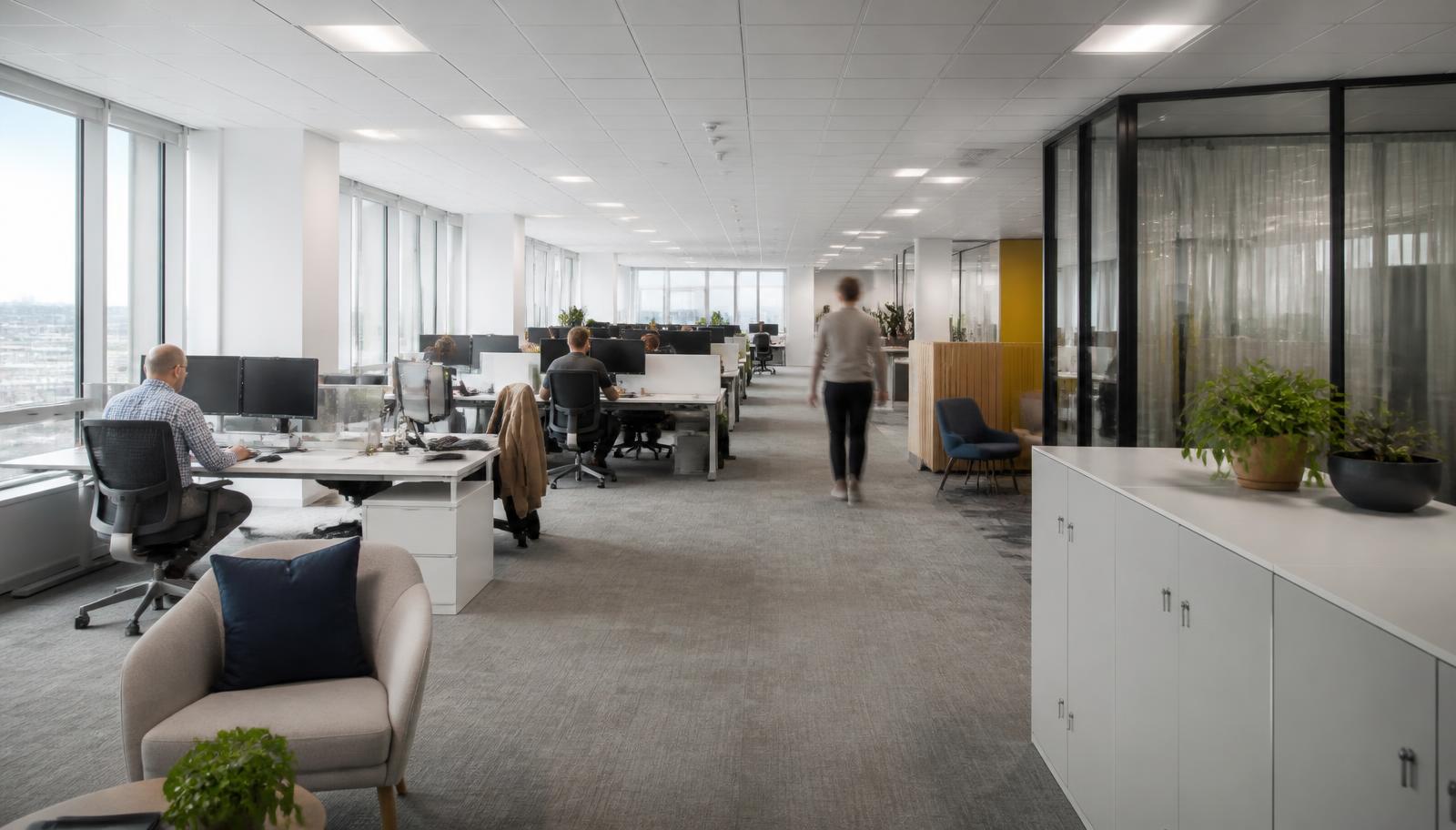 Partially occupied open plan office with people working